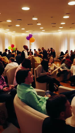 guests enjoying drinks and conversations at a lively indoor social gathering