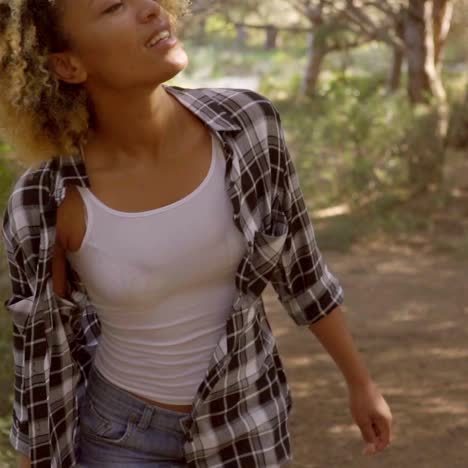 a walking woman on the forest road