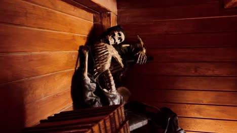 worn skeleton figure sits slumped against a rustic wooden wall, haunting mood