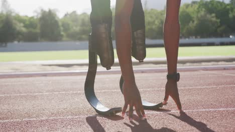 disabled mixed race man with prosthetic legs stretching