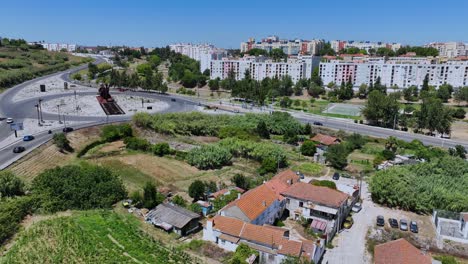 drone shot of a road with a roundabout with a big monumnet in