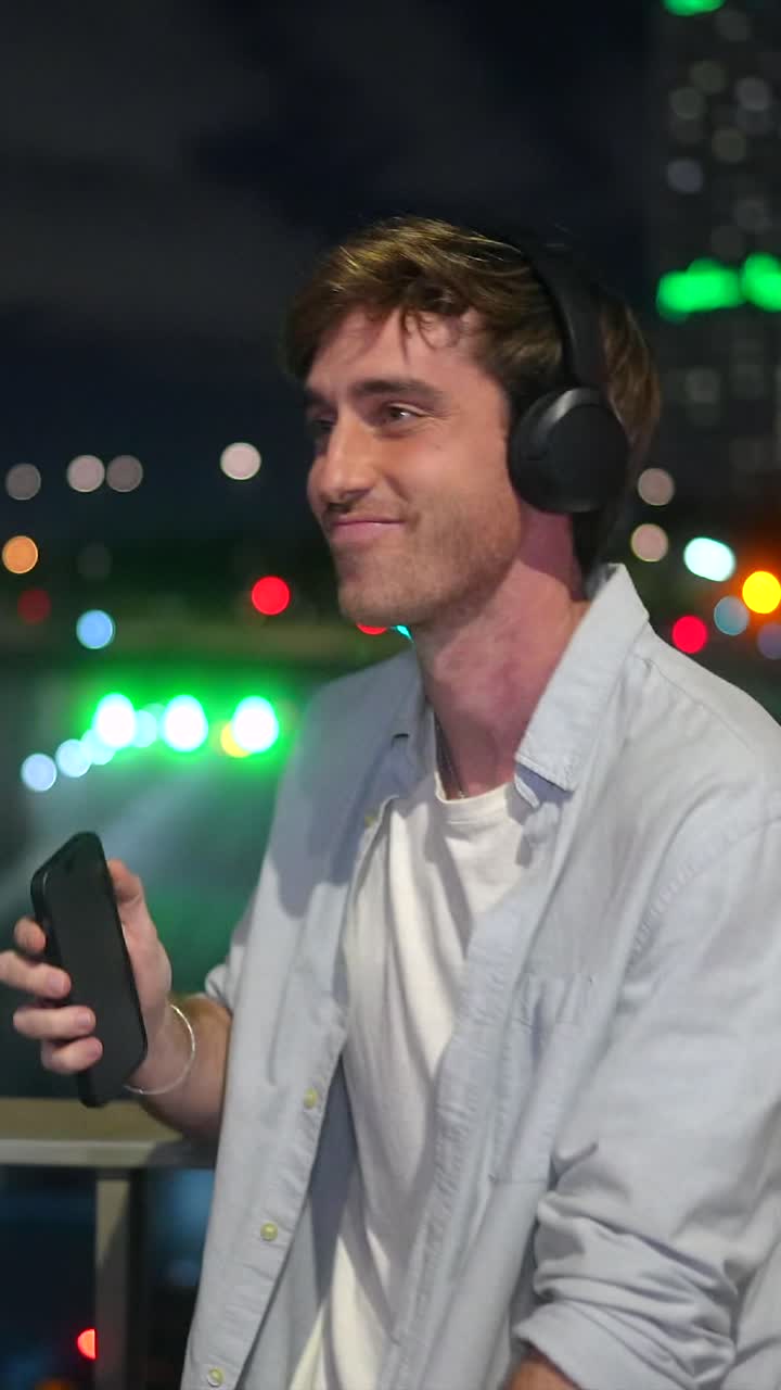 Man listening to music with headphones at night