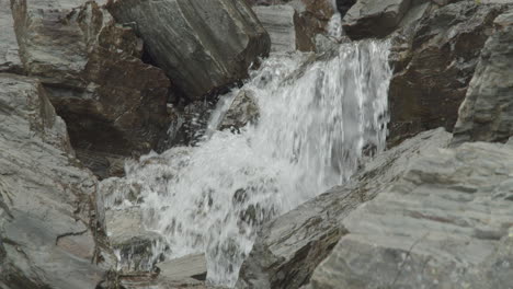 water flows thru rocks in slow motion