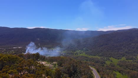 Drone-shot-of-smoke-of-fire-getting-caught-in-Crackenback-area-in-New-South-Wales,-Australia