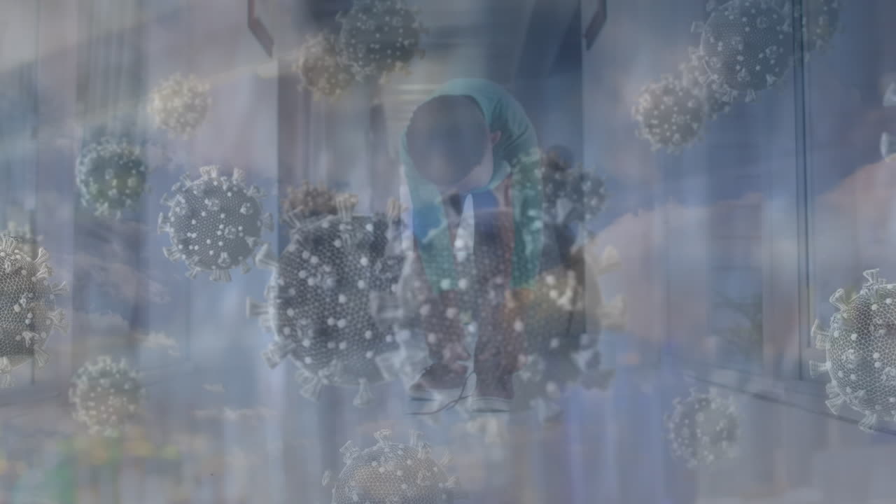 animación de células de virus y cielo con nubes sobre un niño caucásico atando cordones de zapatos