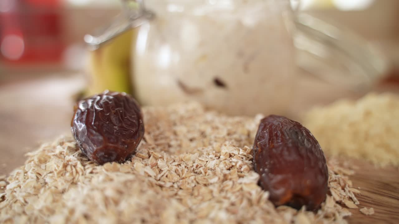 Dried Date Fall into Pile of Oat Flakes, Selective Focus with Copy Space