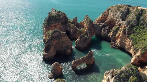 top view of enclosure of rocky formations in ponta da piedade, algarve, lagos, portugal - aerial descending fly-over shot