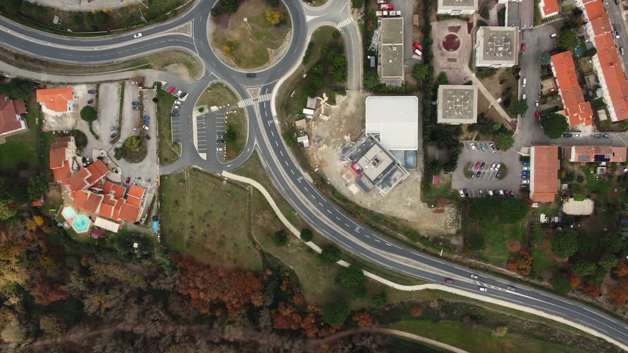 Aerial view of a European town with roundabouts and construction site
