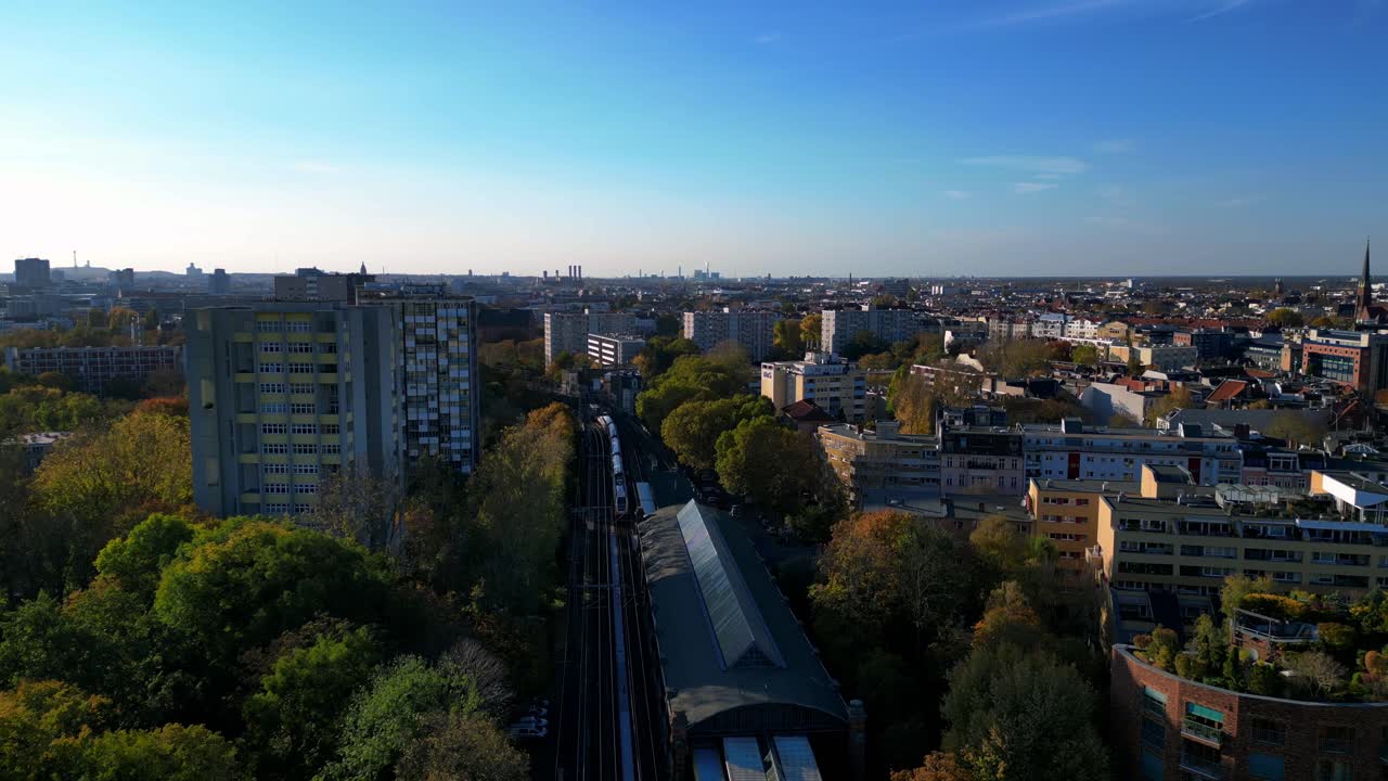 Aerial View of a City with Train Station and Surrounding Buildings