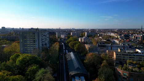 aerial view of a city with train station and surrounding buildings