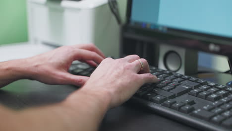 person typing on a computer keyboard