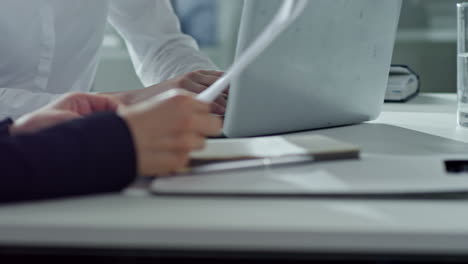 business partners discussing project sitting on desk at meeting in the office