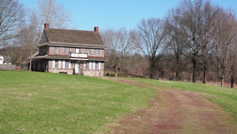 dirt road leads to 18th century colonial house