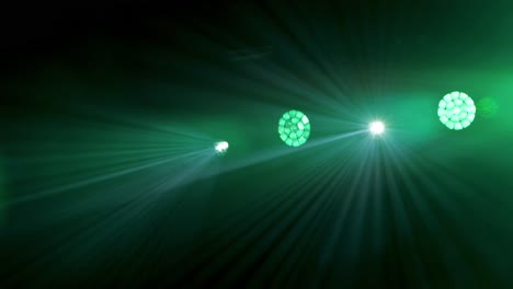 camera pans across bright green stage lights causing a purple lens flare