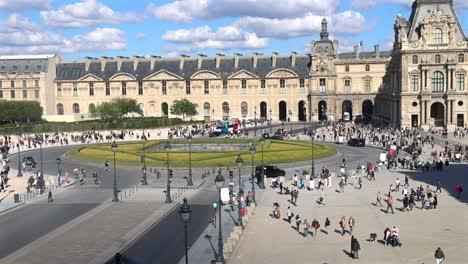 crowded square in front of the louvre museum in paris