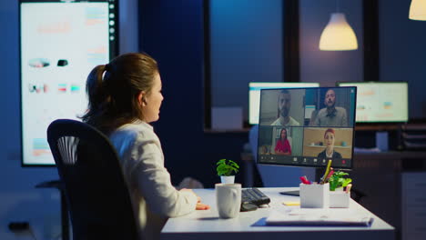 Businesswoman-talking-during-video-conference-with-team-in-midnight
