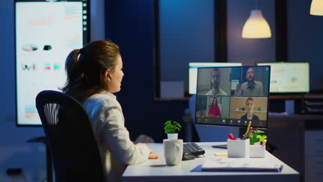 businesswoman talking during video conference with team in midnight