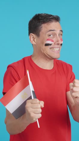 Man cheering for Egypt during a match that is lost