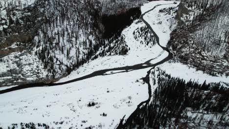 Aerial-bird-view-revealing-a-breathtaking-fairytale-snowy-landscape-in-Canada