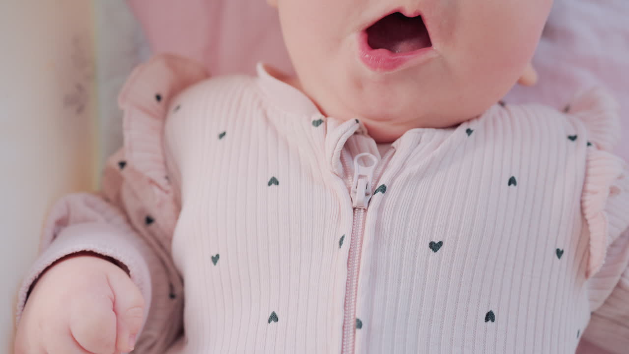 Close up of baby's lips and cheeks in warm pastel light