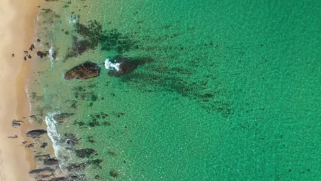 Aerial-shot-of-sandy-beach-and-tropical-turquoise-sea-waves