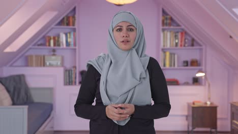 serious muslim woman talking to the camera