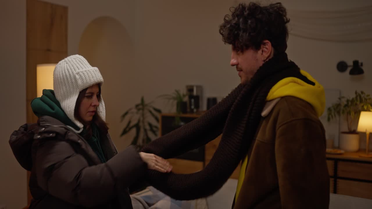 Couple sharing warm winter clothes