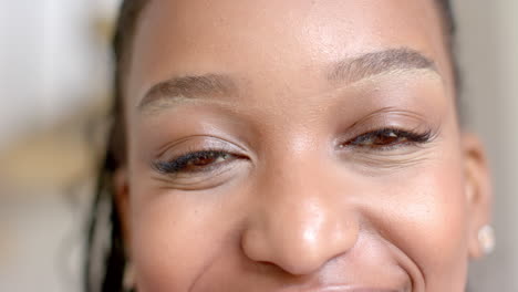 african american young woman with smiling face, wearing makeup