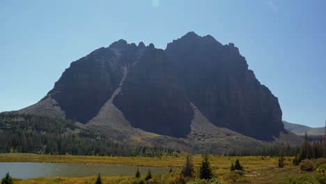 stunning nature landscape tilting down shot of the incredible red castle peak up a backpacking trail in the high uinta national forest between utah and wyoming with a fishing lake to the left