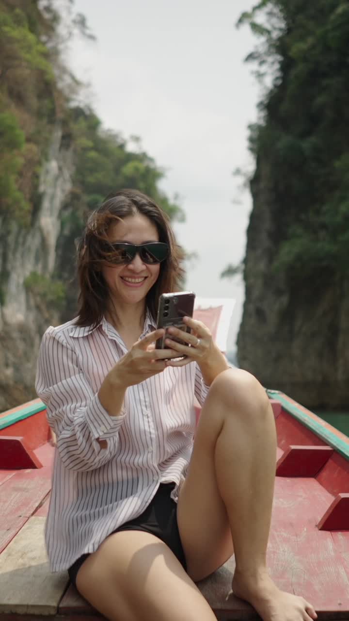 Woman taking selfie on a boat