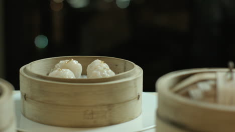 opening the wooden steamers with chinese dumplings