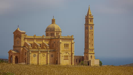 Timelapse of Bażilika Tal-Madonna Ta&#039; Pinu Mill Gharb across field