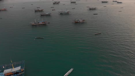 Flying-over-docked-fishing-boats-at-Belitung-Indonesia,-aerial