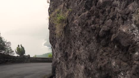 mountain road with ocean view in volcanic landscape