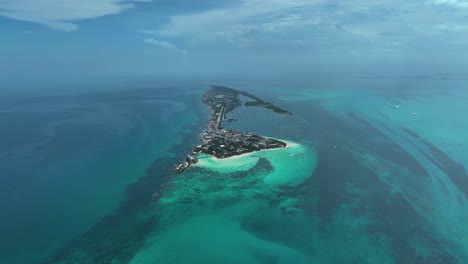 aerial view overlooking the isla mujeres island in sunny mexico - high altitude, orbit, drone shot