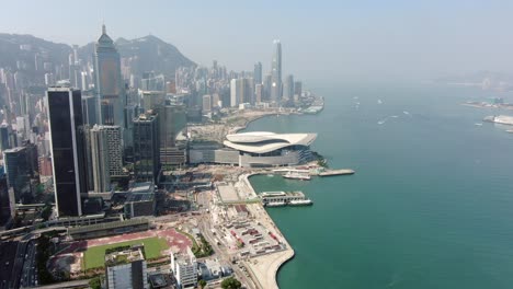 Hong-Kong-upscale-Wan-Chai-district-and-Victoria-Harbour-skyscrapers,-Aerial-view