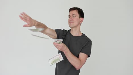 man throwing cash in the air, symbolizing wealth and financial success