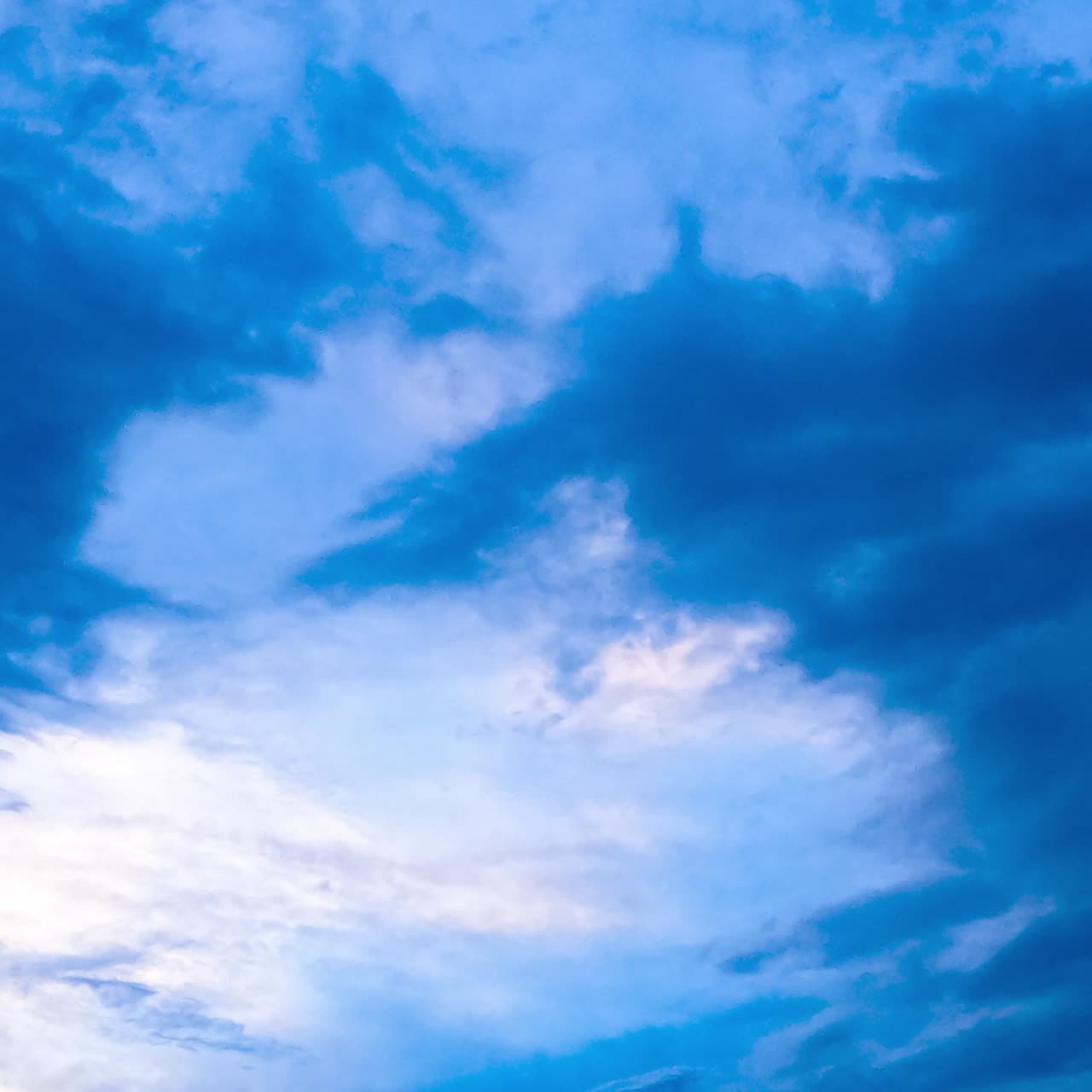 Beautiful sky lit with the setting sun. Clouds changing shapes and accumulating into dark cloudscape. Low angle view. Timelapse