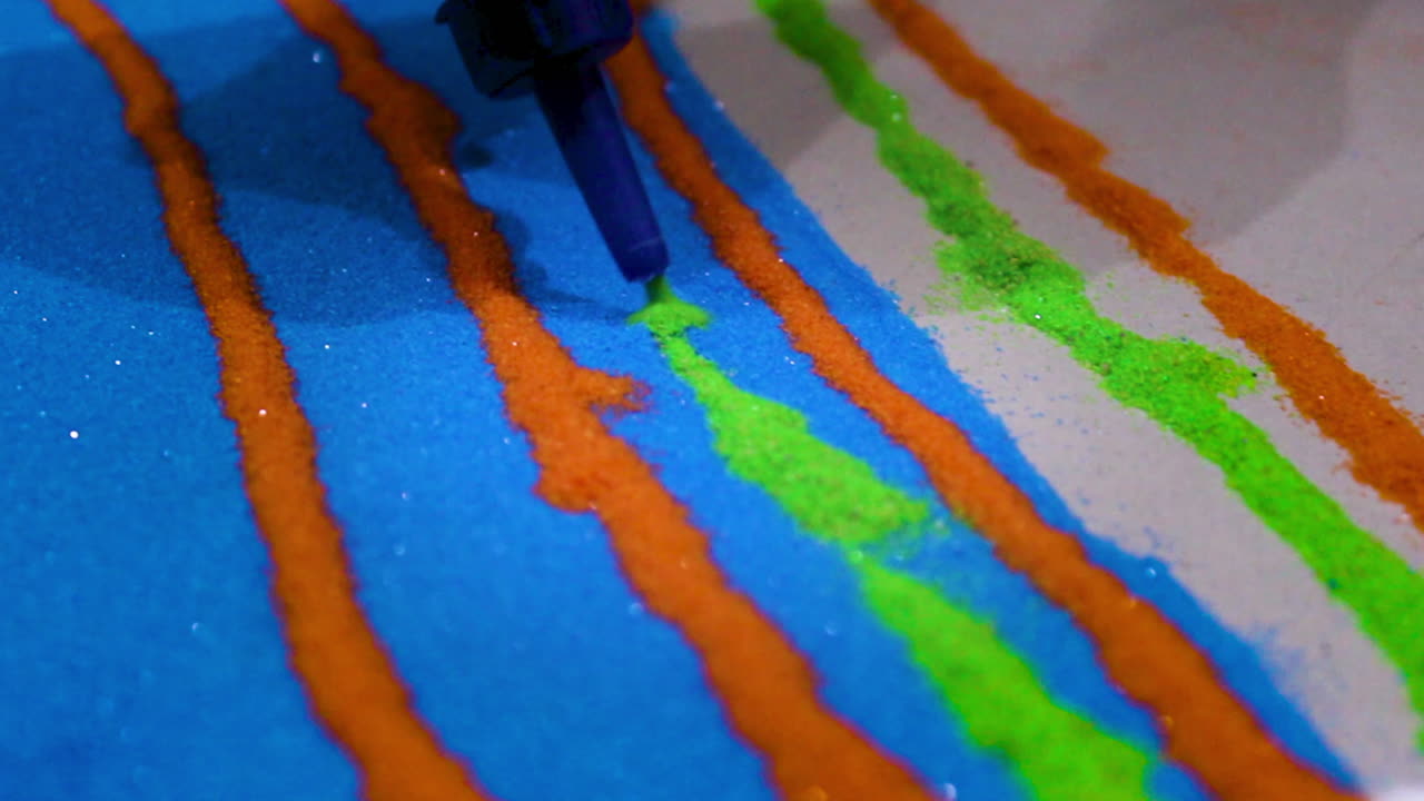 Rangoli art comes alive with colorful powders in blue, orange, green layers. Glue bottle draws precise lines for traditional Indian festival designs full of cultural flair