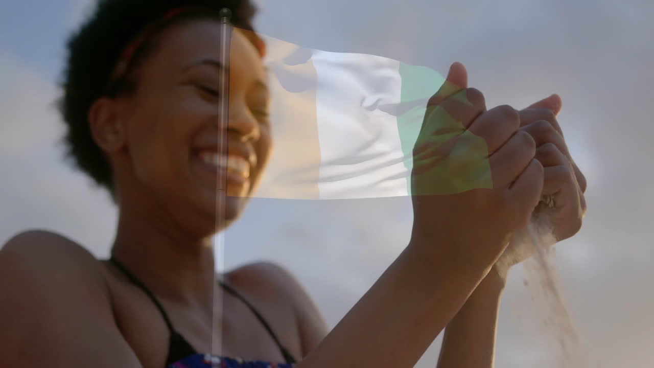 Holding sand with Irish flag overlay, woman smiling in animation background