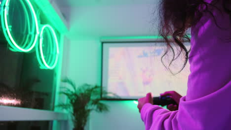 person gaming in a neon-lit room