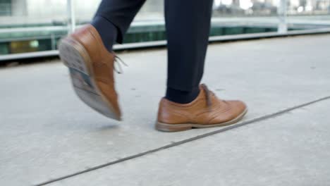 Cropped-shot-of-businessman-walking-on-street