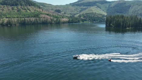 aerial view of a motorboat pulling an inner tube on spirit lake, idaho