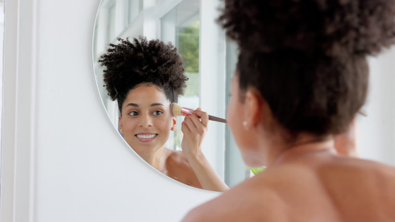 Black woman, mirror and makeup brush for morning