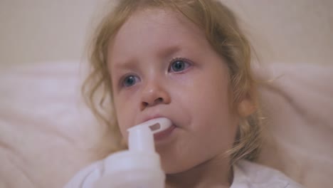 pretty girl has procedure with inhaler in bed closeup