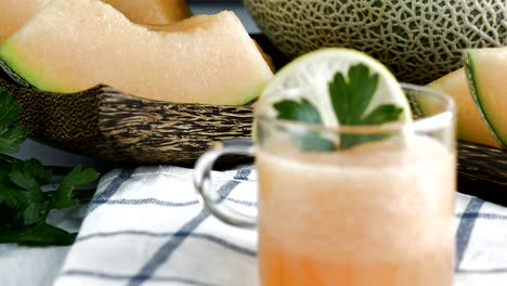 whole and sliced of japanese melons,honey melon or cantaloupe (cucumis melo) glass of melon smoothie healthcare concept.