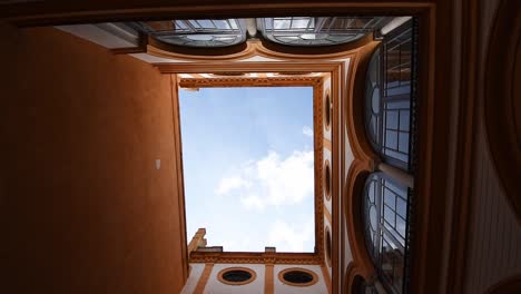 Looking-a-bright-orange-walls-of-a-patio-of-,-Real-Alcazar,-Seville,-Andalusia,-Spain