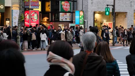 busy crosswalk in downtown tokyo, japan. people hurrying across the street.