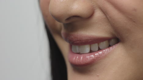 close up woman mouth smiling cheerful glossy lips healthy teeth concept on white background