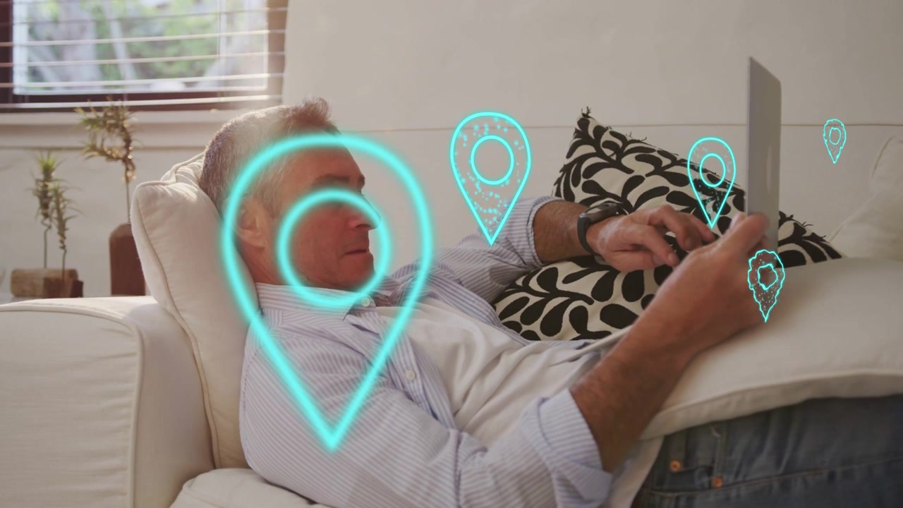 Mature man reclining sofa, tapping tablet and generating pulsing AR location pins for mapping tech